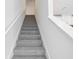 Carpeted staircase with white banister at 16443 Bird Of Paradise Ave, Clermont, FL 34714