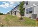 This backyard features a patio, a newly seeded lawn, and fresh landscaping ready for your personal touch at 16443 Bird Of Paradise Ave, Clermont, FL 34714