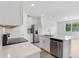 Open concept kitchen featuring white cabinets, stainless steel appliances, and an island at 16443 Bird Of Paradise Ave, Clermont, FL 34714