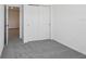 Bedroom featuring neutral carpet, closet doors, and an open doorway at 16443 Bird Of Paradise Ave, Clermont, FL 34714