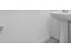 White pedestal sink paired with gray tile floors at 16443 Bird Of Paradise Ave, Clermont, FL 34714