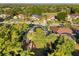 Aerial view of home with pool, firepit, trampoline and lush landscaping at 189 Hammock Oak Cir, Debary, FL 32713