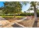 Backyard features a fire pit area, mature trees, and well-manicured landscaping at 189 Hammock Oak Cir, Debary, FL 32713