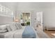 Light and airy bedroom with a patio view, light wood floors, white accents, and neutral color scheme at 189 Hammock Oak Cir, Debary, FL 32713