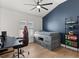 A bedroom with a ceiling fan, a blue accent wall, a twin bed with drawers and a gamer theme at 189 Hammock Oak Cir, Debary, FL 32713