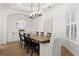 Elegant dining room featuring a large wood table, modern lighting, and built-in storage at 189 Hammock Oak Cir, Debary, FL 32713