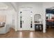 Bright entryway featuring a white front door, wood floors, and a stylish accent table at 189 Hammock Oak Cir, Debary, FL 32713