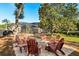 Outdoor fire pit area with seating surrounded by mature trees and landscaping at 189 Hammock Oak Cir, Debary, FL 32713