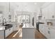 Well-lit kitchen boasting white cabinetry, a center island, and stainless steel appliances at 189 Hammock Oak Cir, Debary, FL 32713