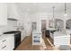 Contemporary kitchen featuring white cabinets, granite countertops, and stainless steel appliances at 189 Hammock Oak Cir, Debary, FL 32713