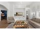 Bright living room featuring hardwood floors, stylish furniture, and custom built-in shelving at 189 Hammock Oak Cir, Debary, FL 32713