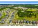Community aerial showing homes, a lake, and a nearby school and baseball field at 1910 Donahue Dr, Ocoee, FL 34761