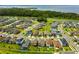Aerial view showcases the community layout with homes nestled amongst trees and a large lake nearby at 1910 Donahue Dr, Ocoee, FL 34761