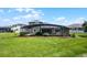Wide shot of a beautiful backyard boasting green grass and a screened in porch at 1910 Donahue Dr, Ocoee, FL 34761