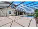 A backyard featuring an inviting pool, well-maintained patio, and string lights under a screened enclosure at 1910 Donahue Dr, Ocoee, FL 34761