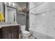 Well-lit bathroom with a dark wood vanity, granite countertop and tiled shower-tub combination at 1910 Donahue Dr, Ocoee, FL 34761