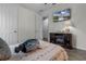 Cozy bedroom featuring wood-look tile floors, television and ensuite bathroom at 1910 Donahue Dr, Ocoee, FL 34761