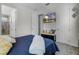 A bedroom boasts a comfortable bed, television and an open doorway to the bathroom at 1910 Donahue Dr, Ocoee, FL 34761
