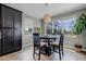 Bright breakfast nook features a modern light fixture, wood-look tile floors, and views of the lanai at 1910 Donahue Dr, Ocoee, FL 34761
