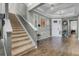 Elegant foyer with wood floors, staircase, and decorative wall accents at 1910 Donahue Dr, Ocoee, FL 34761