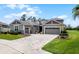 Charming home with a well-maintained lawn, beautiful landscaping, and a stylish driveway at 1910 Donahue Dr, Ocoee, FL 34761
