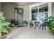 Charming front porch with black door, a window and a seating area with lush greenery at 1910 Donahue Dr, Ocoee, FL 34761