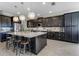 Spacious kitchen with a large island, dark cabinetry, and modern appliances at 1910 Donahue Dr, Ocoee, FL 34761
