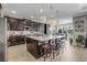 Bright kitchen with a granite island, stainless steel appliances, and dark cabinets at 1910 Donahue Dr, Ocoee, FL 34761