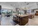 Open concept kitchen and breakfast nook with a view to the lanai and living area at 1910 Donahue Dr, Ocoee, FL 34761