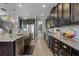 Gourmet kitchen features stainless steel appliances, granite countertops, and dark wood cabinets at 1910 Donahue Dr, Ocoee, FL 34761