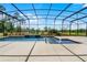 Sparkling pool inside a screened enclosure with water features and lush landscaping at 1910 Donahue Dr, Ocoee, FL 34761