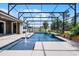 Screened-in swimming pool showcasing a fountain, well-manicured greenery and a comfortable lounge area at 1910 Donahue Dr, Ocoee, FL 34761