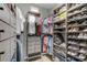 Organized walk-in closet features shelving for shoes, drawers for clothes and hanging areas at 1910 Donahue Dr, Ocoee, FL 34761