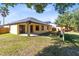 A large backyard with an extended patio, shed, garden bed, and lush lawn at 19319 Briercrest Trl, Orlando, FL 32833