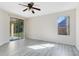 Spacious bedroom featuring new flooring, a ceiling fan, and a sliding glass door to the patio at 19319 Briercrest Trl, Orlando, FL 32833
