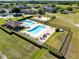 Aerial view of the community pool, playground, and the surrounding fence and trees at 19319 Briercrest Trl, Orlando, FL 32833