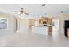 Open-concept kitchen with bar, wood cabinets, and view into the living area with natural light at 19319 Briercrest Trl, Orlando, FL 32833
