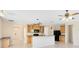 Well-lit kitchen featuring wooden cabinets, black appliances, bar seating, and tile flooring at 19319 Briercrest Trl, Orlando, FL 32833