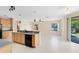 Bright kitchen area with wood cabinets, black appliances, and an island with pendant lighting at 19319 Briercrest Trl, Orlando, FL 32833