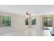Bright living room with large windows and a sliding glass door showcasing the fenced yard at 19319 Briercrest Trl, Orlando, FL 32833