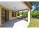 Covered patio with views of the backyard landscaping, and natural light at 19319 Briercrest Trl, Orlando, FL 32833