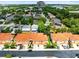 An aerial view of a community showcases well-maintained homes with colorful roofs and mature trees at 1998 Michael Tiago Cir, Maitland, FL 32751