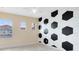 A whimsically decorated bedroom with a soccer ball accent wall and natural light from two windows at 1998 Michael Tiago Cir, Maitland, FL 32751
