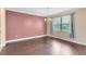 Bright dining room featuring hardwood floors, elegant chandelier, and large window for natural light at 1998 Michael Tiago Cir, Maitland, FL 32751
