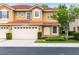 Charming two-story townhome featuring a two-car garage, manicured landscaping, and terracotta tile roof at 1998 Michael Tiago Cir, Maitland, FL 32751