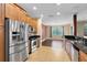 Modern kitchen boasts stainless steel appliances, granite countertops, and well-lit dining area at 1998 Michael Tiago Cir, Maitland, FL 32751