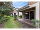 A covered patio overlooks a lush, manicured backyard at 1998 Michael Tiago Cir, Maitland, FL 32751