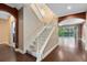 Carpeted staircase with white banisters leading to upper level and natural light at 1998 Michael Tiago Cir, Maitland, FL 32751