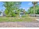 Charming bungalow with a screened porch, lush landscaping, and a brick-paved street at 2011 Harmon Ave, Winter Park, FL 32789