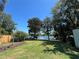 Expansive backyard with mature trees, waterfront view, and space for outdoor activities at 2154 Lake Christie Dr, Orlando, FL 32809